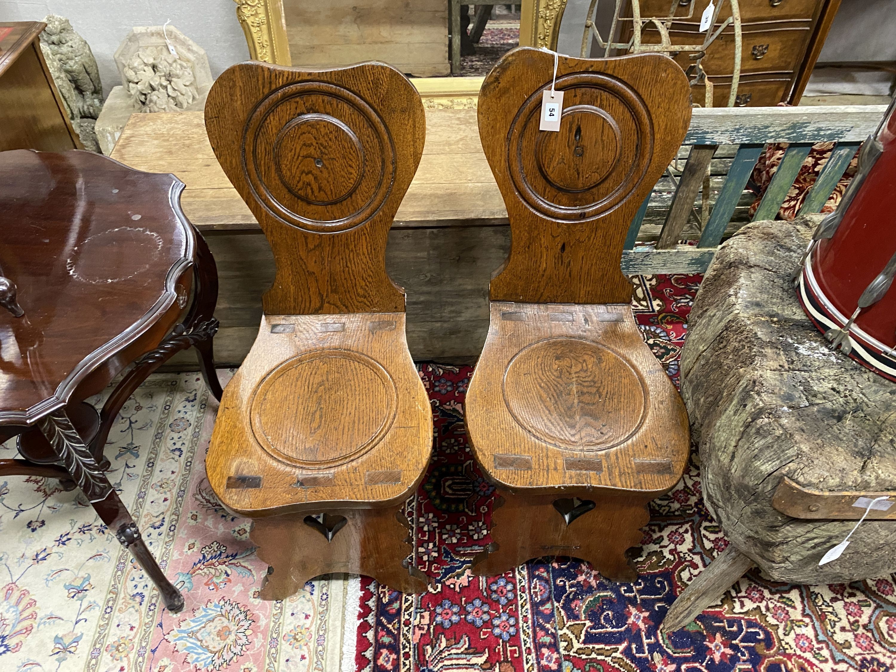 A pair of 18th century style Italian oak hall chairs, width 38cm, depth 50cm, height 91cm